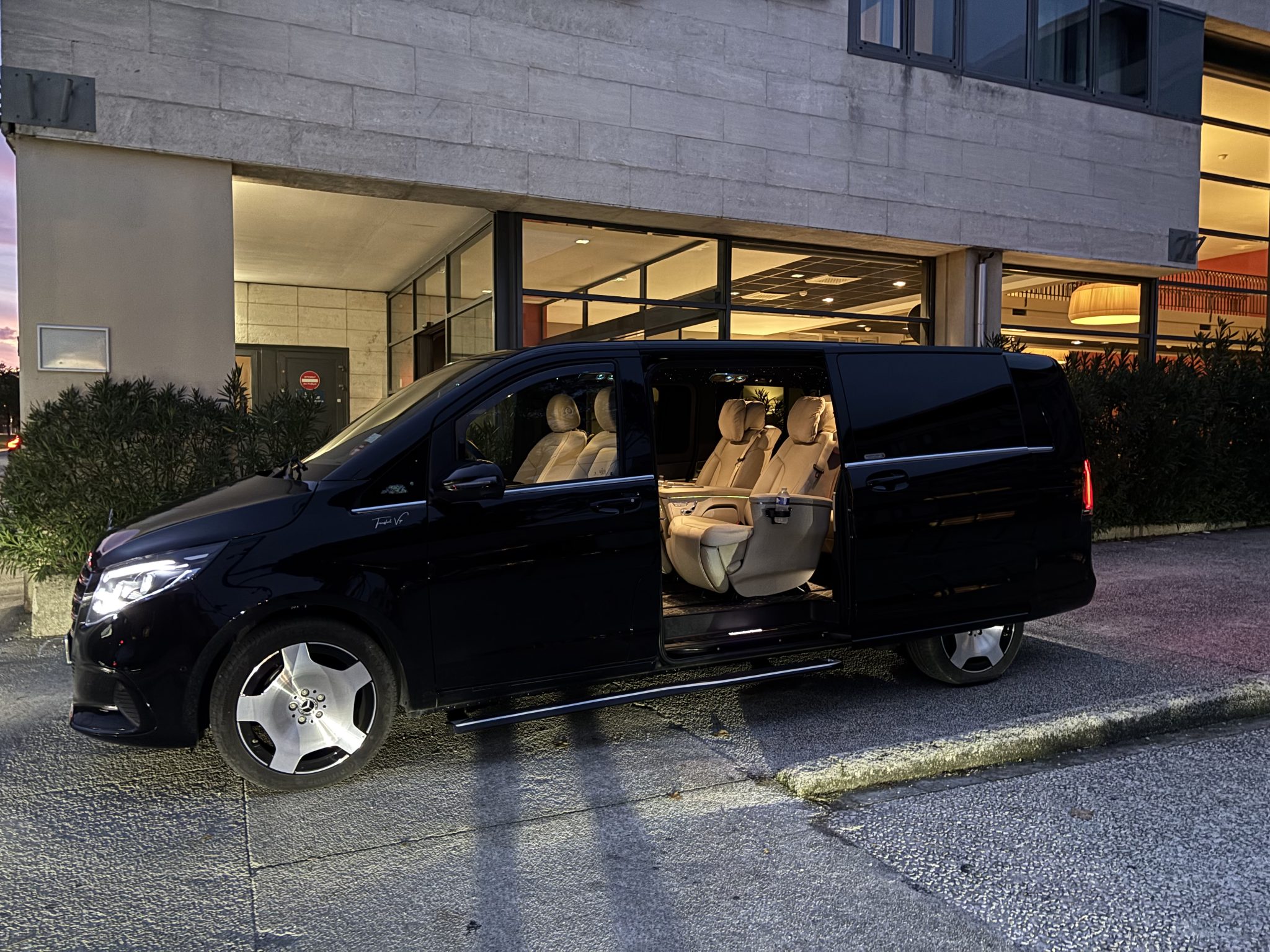 Mercedes Classe VIP noire avec chauffeur privé devant l'hôtel, transfert vers les stations de ski à Chamonix